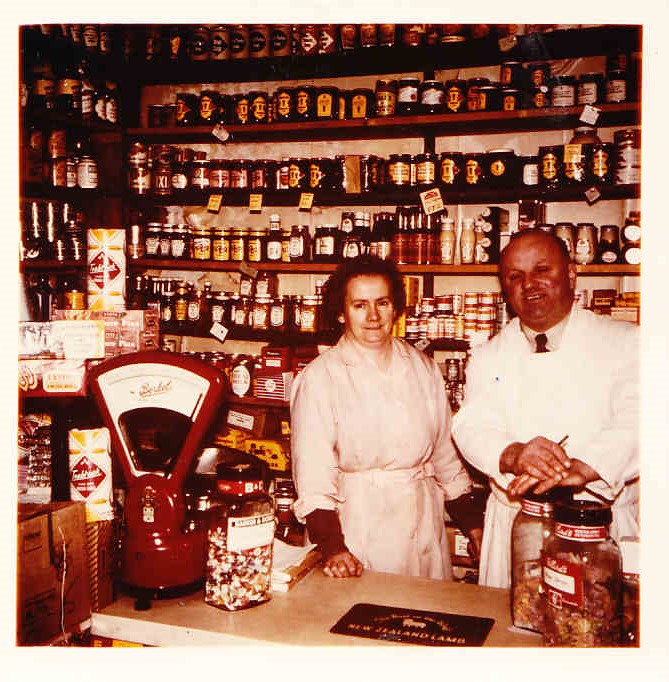 Mr and Mrs Ryder behind the counter of their grocery shop