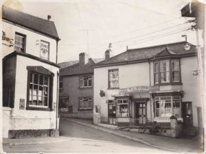 Black and white photo of the shop at the corner of Fore St. and Radway Hill