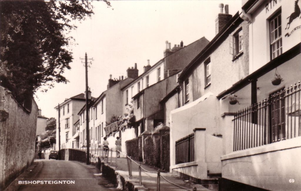 Black and White postcard of Fore Street, Bishopsteignton showing position of blacksmith.