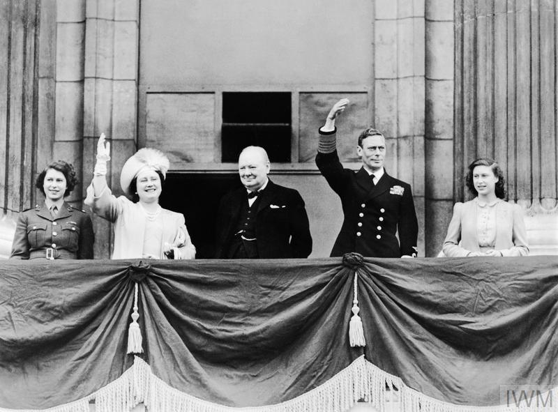 VE DAY CELEBRATIONS IN LONDON, 8 MAY 1945 (MH 21835) HM King George VI and Queen Elizabeth with Princess Elizabeth and Princess Margaret joined by the Prime Minister, Winston Churchill on the balcony of Buckingham Palace, London on VE Day. Copyright: © IWM. Original Source: http://www.iwm.org.uk/collections/item/object/205021954