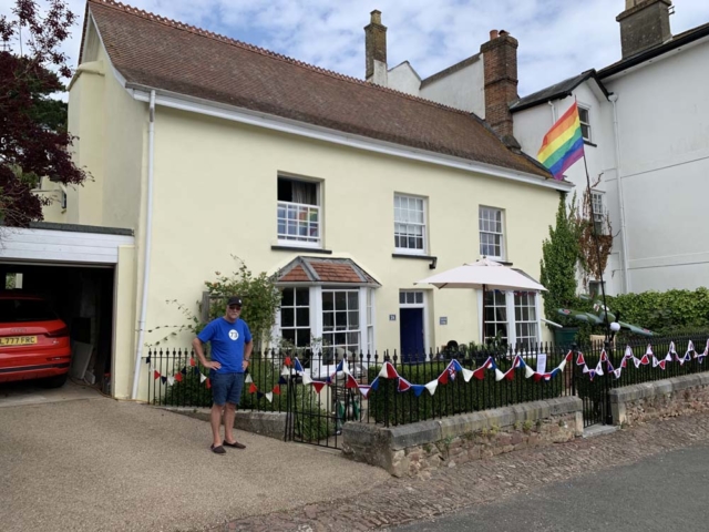 Terry standing proud and waving the flag for VE Day 75