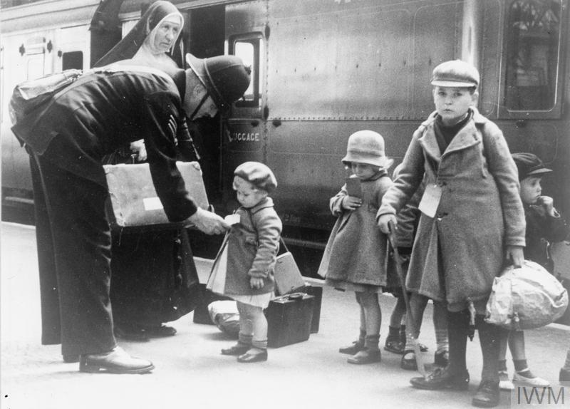 THE CIVILIAN EVACUATION SCHEME IN BRITAIN DURING THE SECOND WORLD WAR (LN 6194) A policeman helps some young evacuees, and a nun who is escorting them, at a London station. Copyright: © IWM. Original Source: http://www.iwm.org.uk/collections/item/object/205019036