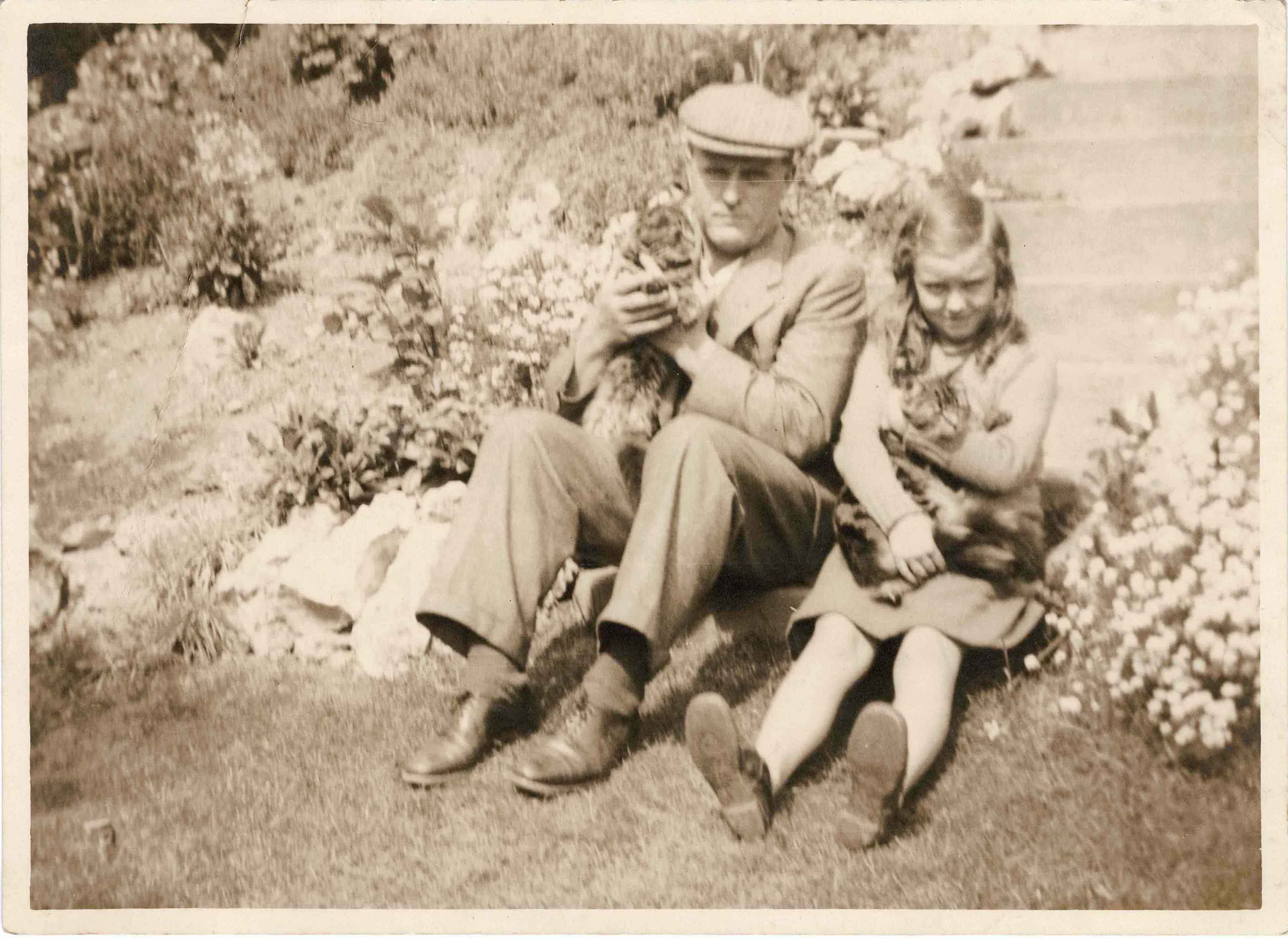 Photograph of Philip and Molly Coombe with cats, c. 1935.