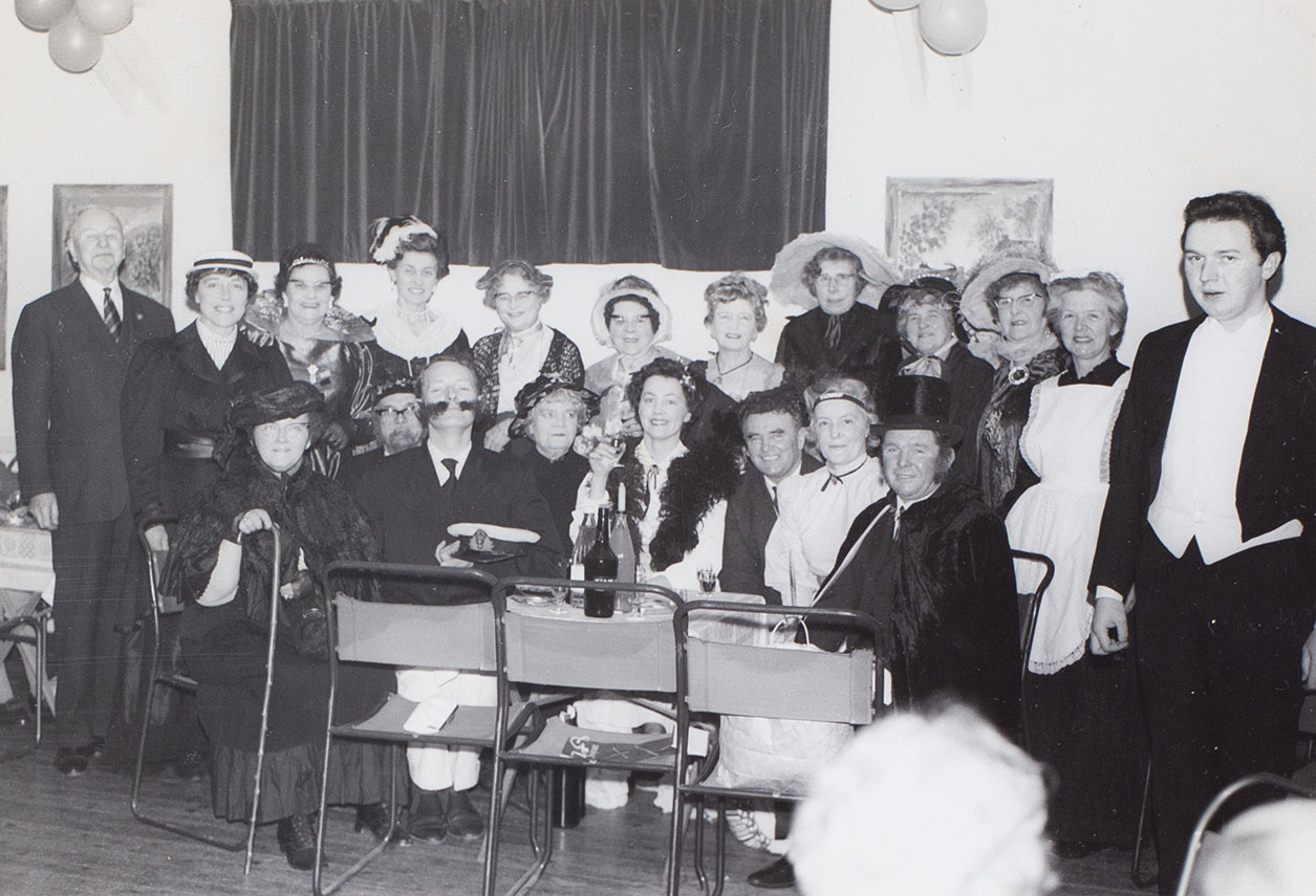 Photograph of actors and/or crew from the Bishopsteignton Players, at a social gathering in the 1960s