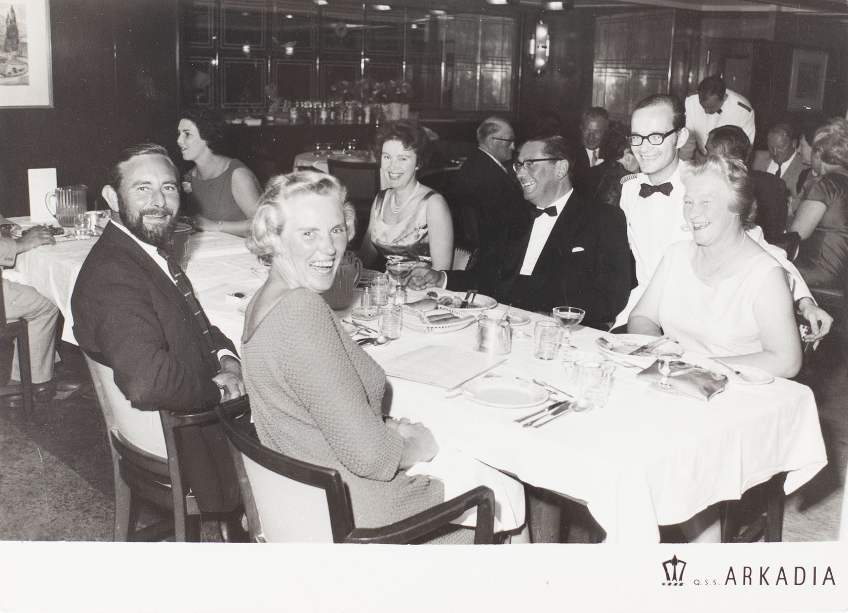 Photograph of a group at dinner on the cruise liner Q.S.S. Arkadia