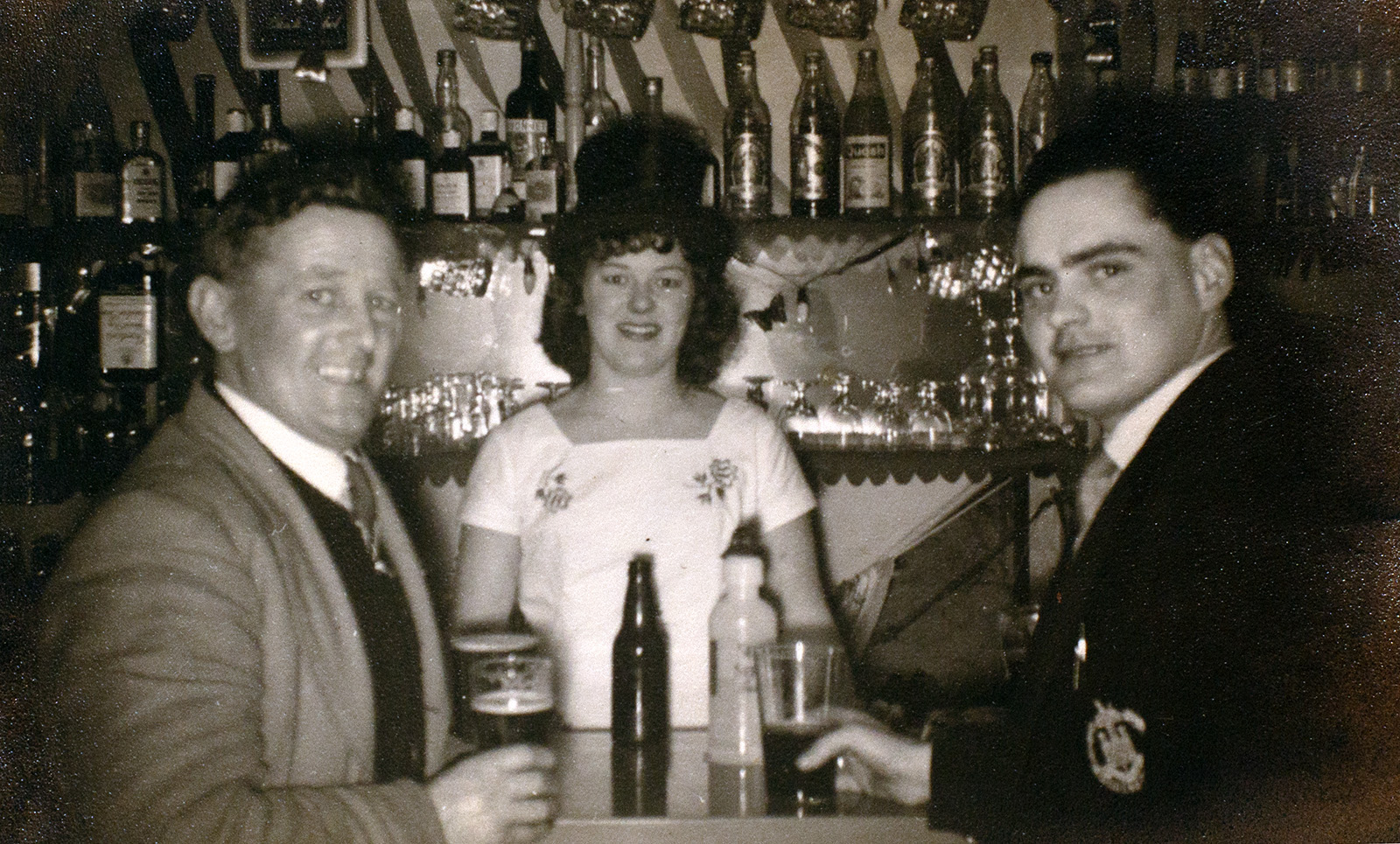 Photograph of the Landlady and patrons taken inside The Manor Inn